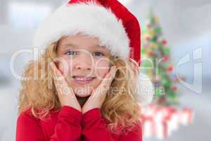 Composite image of cute girl in santa hat