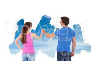 Composite image of couple painting together