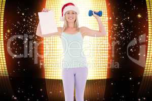 Composite image of festive fit blonde holding page and dumbbell