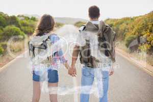 Composite image of hiking couple standing on countryside road