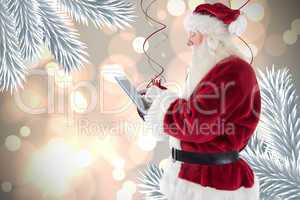 Composite image of santa uses a tablet pc