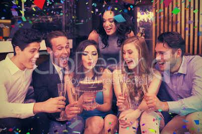 Composite image of attractive friends celebrating a birthday