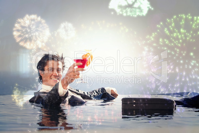 Composite image of cheerful businessman relaxing in a swimming p