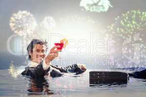 Composite image of cheerful businessman relaxing in a swimming p