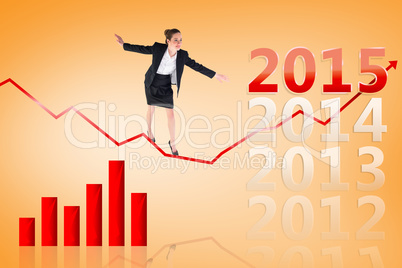 Composite image of businesswoman performing a balancing act