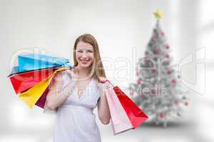 Composite image of blonde with shopping bags