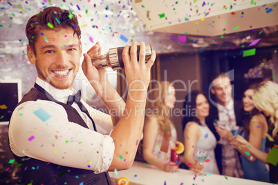 Composite image of handsome barman smiling at camera making a co