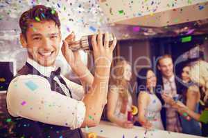 Composite image of handsome barman smiling at camera making a co