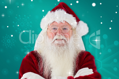 Composite image of santa smiles with folded arms