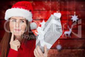 Composite image of redhead holding gift