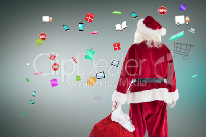 Composite image of santa carrying sack of gifts