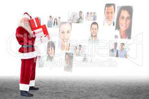 Composite image of santa carrying gifts