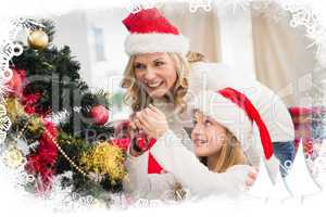 Composite image of festive mother and daughter decorating christ