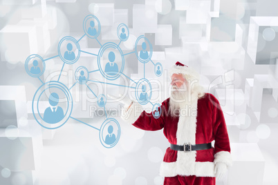 Composite image of santa shows something to camera