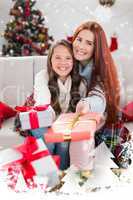 Composite image of festive mother and daughter wrapped in blanket with gifts