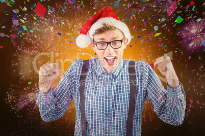 Composite image of geeky hipster wearing santa hat