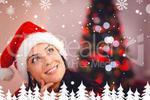 Composite image of festive brunette wearing a santa hat