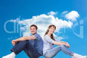 Composite image of couple both sitting on floor