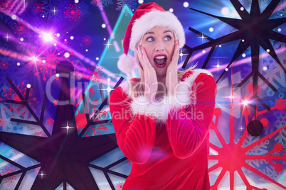 Composite image of festive blonde with hands on face