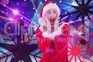 Composite image of festive blonde with hands on face