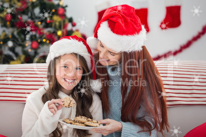 Composite image of festive mother and daughter on the couch with