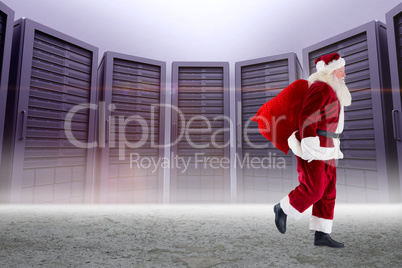 Composite image of santa carrying sack of gifts