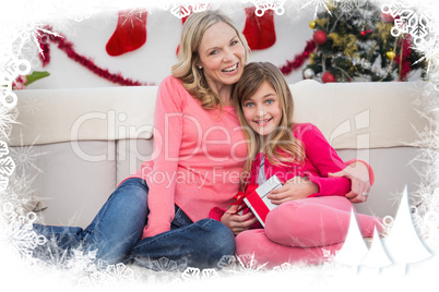 Composite image of festive mother and daughter smiling at camera