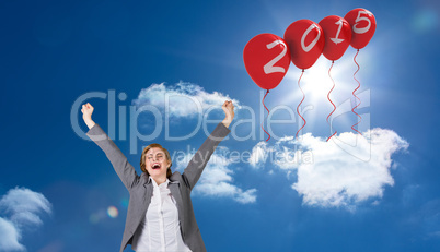 Composite image of excited redhead businesswoman cheering