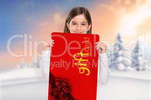 Composite image of cute little girl showing card