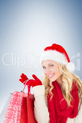 Happy festive blonde with shopping bags