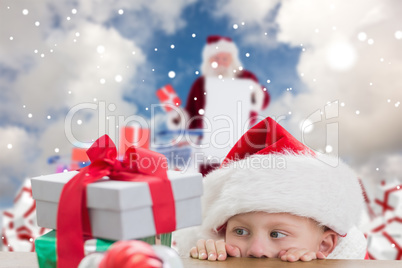 Composite image of cute boy looking at gifts