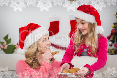 Composite image of festive mother and daughter with plate of coo