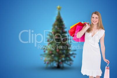 Composite image of happy blonde holding shopping bags in white d