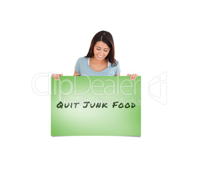 Composite image of gorgeous woman holding a  board