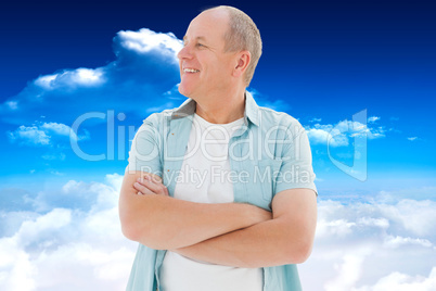 Composite image of happy older man with arms crossed