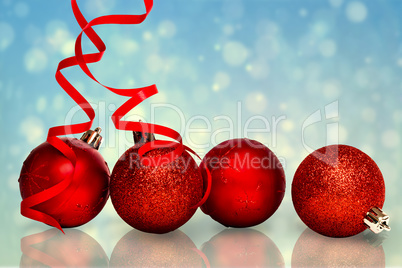 Composite image of four red christmas ball decorations