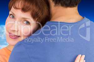 Composite image of happy couple hugging one another