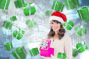 Composite image of brunette opening christmas gift while looking