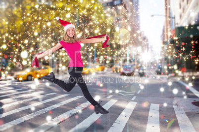 Festive blonde skipping and smiling at camera