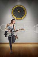 Composite image of pretty young girl playing her guitar