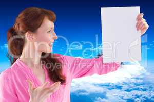 Composite image of surprised woman looking at paper