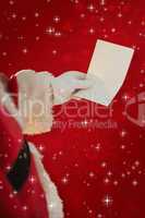 Composite image of father christmas holding a paper