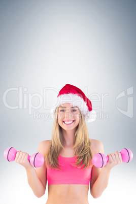 Festive fit blonde holding dumbbells