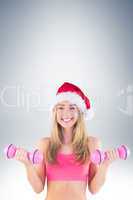 Festive fit blonde holding dumbbells