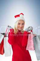 Happy festive blonde with shopping bags