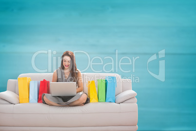 Composite image of woman smiling with laptop