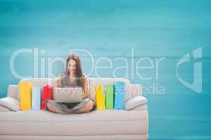 Composite image of woman smiling with laptop