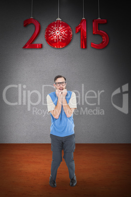 Composite image of geeky hipster looking nervously at camera