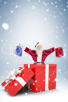 Santa standing in large gift