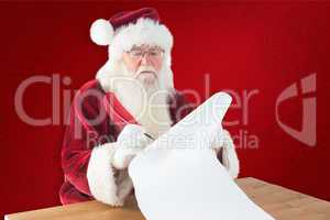 Composite image of santa writes something with a feather
